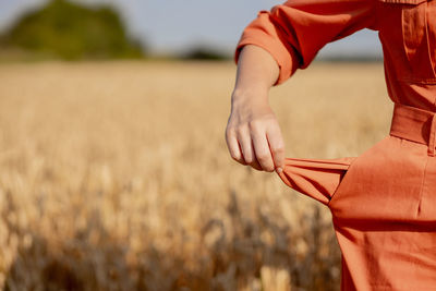 Midsection of woman standing on field