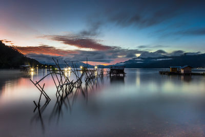 Scenic view of lake against sky at sunset