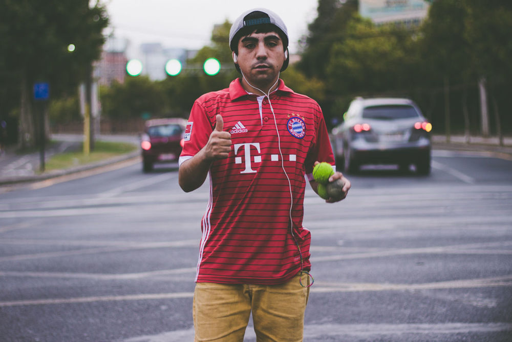 PORTRAIT OF MAN STANDING ON ROAD