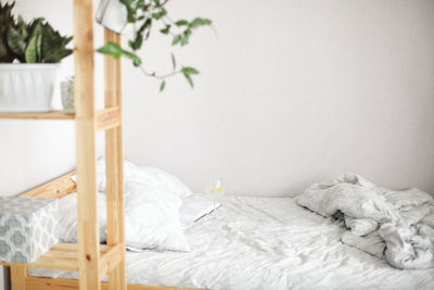 White flowers on bed against wall at home