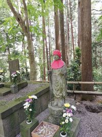 View of statue by flower trees