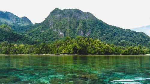 Scenic view of lake and mountains against sky