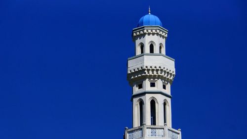 Low angle view of tower of building against blue sky