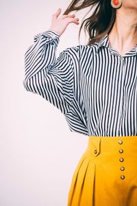 Close-up of young woman against white background