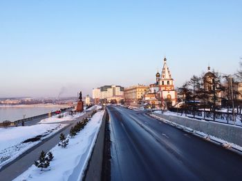 Panoramic view of road in city against clear sky