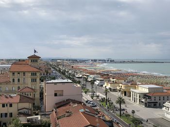 High angle view of buildings by sea against sky