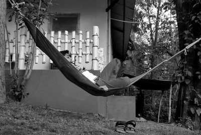 Man sitting in yard against building