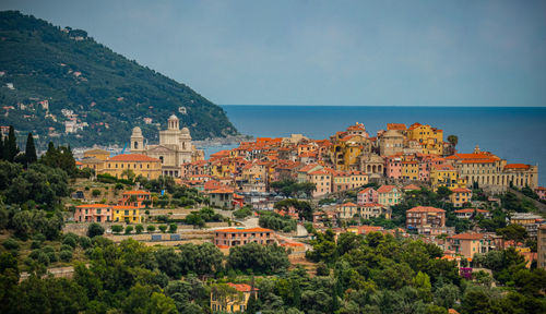 View of townscape by sea against sky