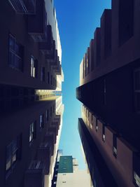 Low angle view of buildings against blue sky