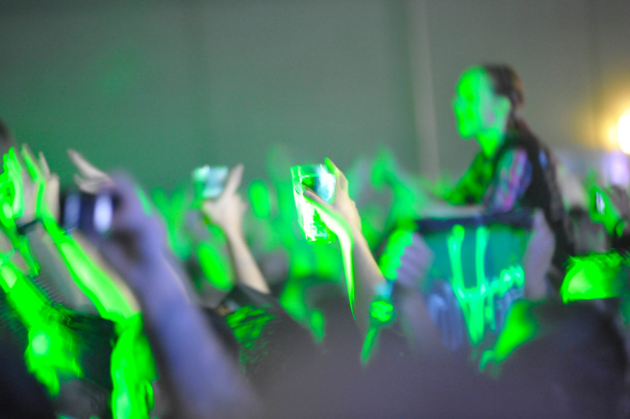 CLOSE-UP OF PEOPLE IN ILLUMINATED NIGHTCLUB