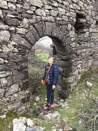 Portrait of young man standing on wall