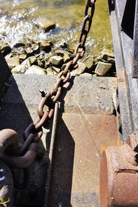 High angle view of chain on rock by river