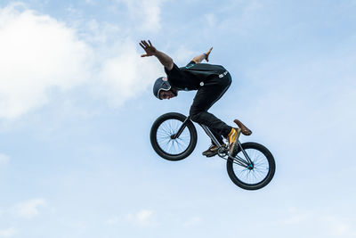 Low angle view of man riding bicycle