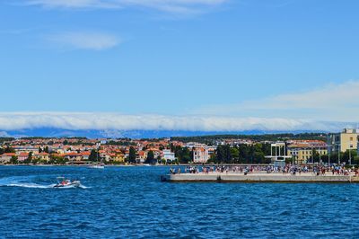 Scenic view of sea and buildings against sky