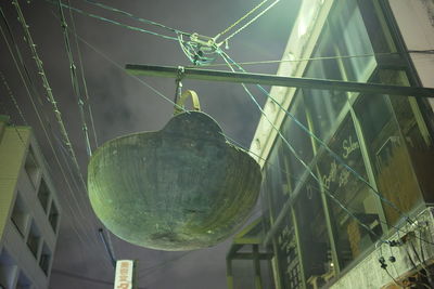 Low angle view of illuminated light bulbs hanging from ceiling