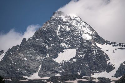 Low angle view of snowcapped mountain against sky