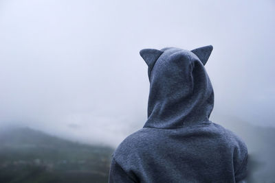 Rear view of person standing on foggy day