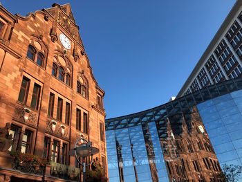 Low angle view of buildings against clear blue sky