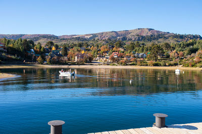 Scenic view of lake against clear blue sky