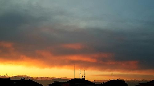 Scenic view of dramatic sky over silhouette landscape