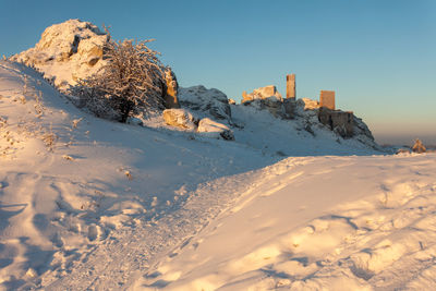 Snow covered land against sky