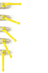 High angle view of adjustable valves over white background