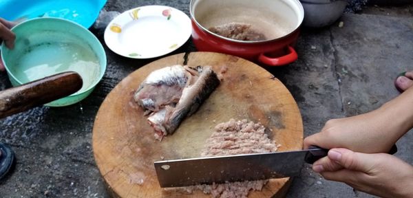 Close-up of person preparing food on cutting board