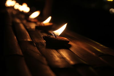 Close-up of burning candle on table