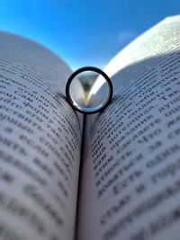 Close-up of wedding rings on book