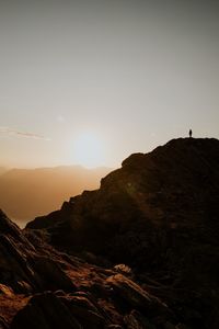 Scenic view of silhouette mountains against sky during sunset