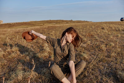 Side view of woman standing on field