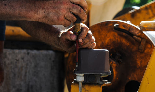 Cropped hand of man working in factory