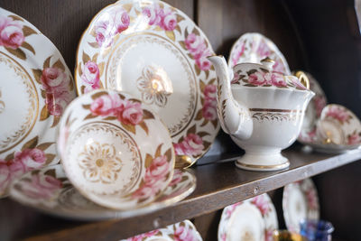 Variety of white plates bowls and tea pots for sale at store