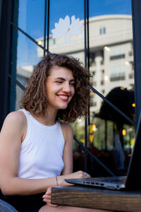 Portrait of young woman using mobile phone