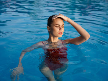 Full length of woman swimming in pool