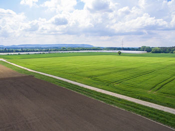 Scenic view of farm against sky