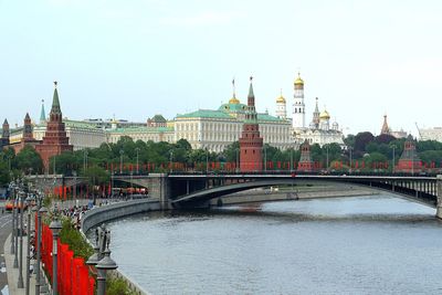Bridge over river against buildings in city