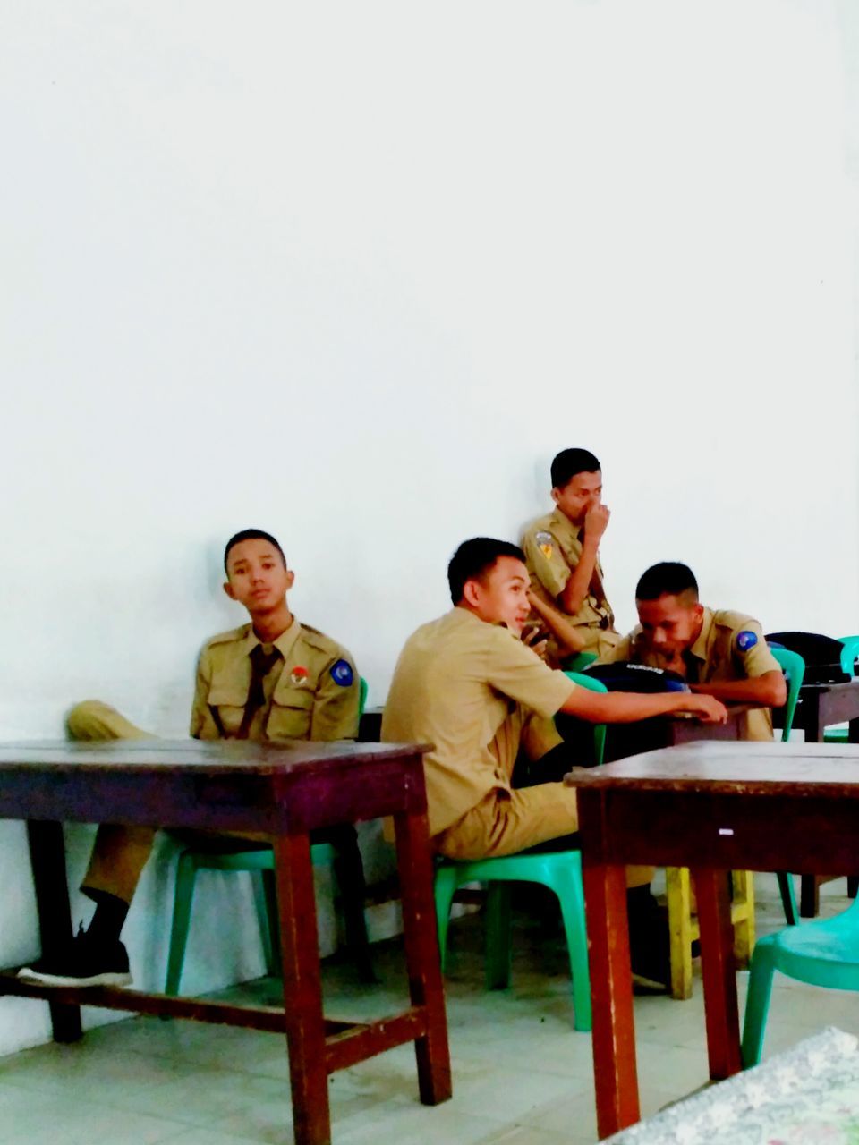 PEOPLE SITTING ON TABLE AND CHAIRS