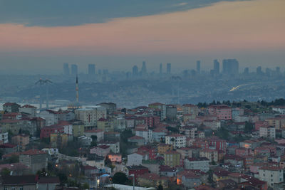 High angle view of buildings in city during sunset