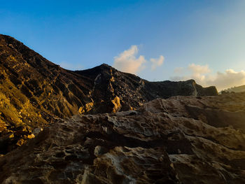 Rock formation on land against sky