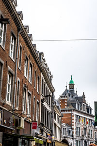 Low angle view of buildings in city against sky