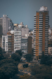 Buildings in city against clear sky