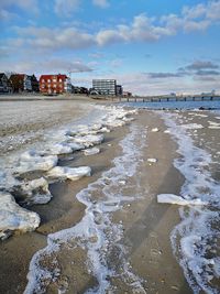 Scenic view of beach against sky during winter