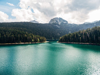 Scenic view of lake and mountains against sky