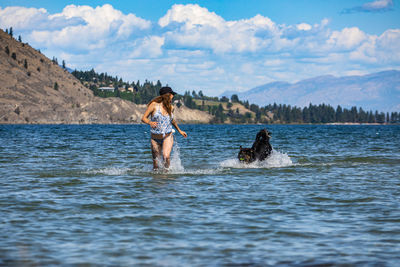 Full length of woman in sea against sky