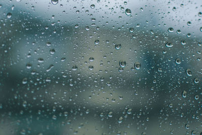 Full frame shot of wet glass window during rainy season