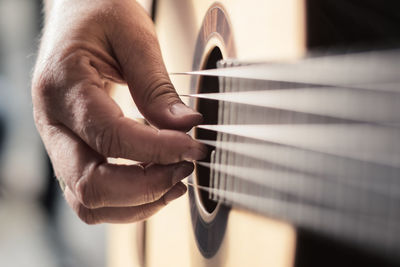 Cropped hands of person playing guitar