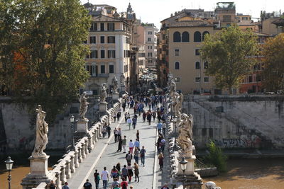 People walking on bridge in city