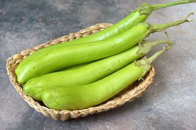 Close-up of green eggplants in basket