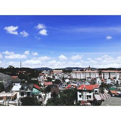 Houses in town against blue sky